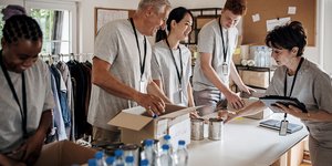 Volunteers sorting donated food and supplies at a community support centre