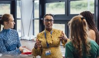 Four people in discussion at a work event