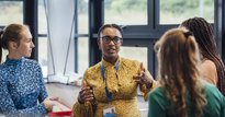 Four people in discussion at a work event