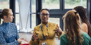 Four people in discussion at a work event