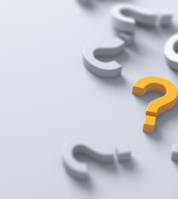 Stock image showing a yellow question mark amongst a number of white question marks