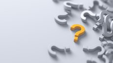 Stock image showing a yellow question mark amongst a number of white question marks